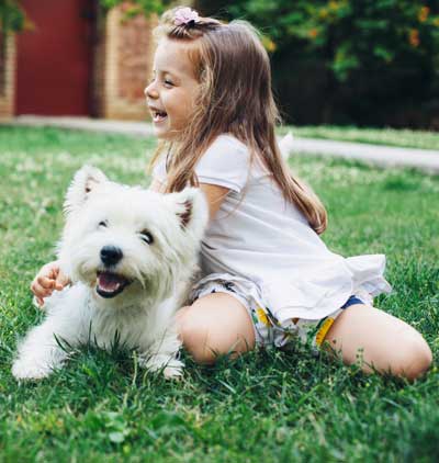 Girl with dog in clean lawn